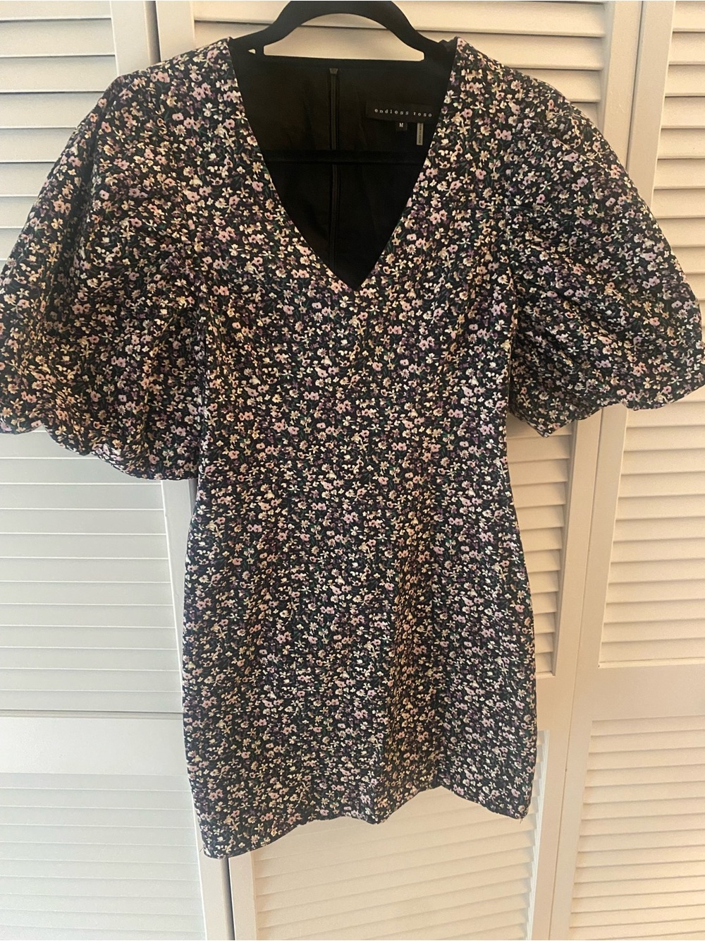 Endless Rose mini dress with puff sleeves. V-neck and fitted waist.